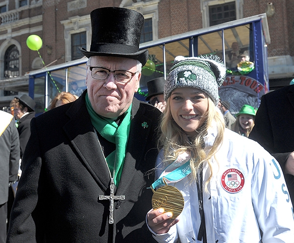 Bishop Richard J. Malone stands with Olympic USA Hockey gold medal winner Emily Pfalzer, of St. Pius X Church in Getzville. The bishop and Pfalzer marched in the City of Buffalo St. Patrick's Day Parade on Delaware Avenue. (Dan Cappellazzo/Staff Photographer)